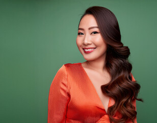 Wall Mural - Portrait of Beautiful Young Woman Happily Smiling Against Studio Background