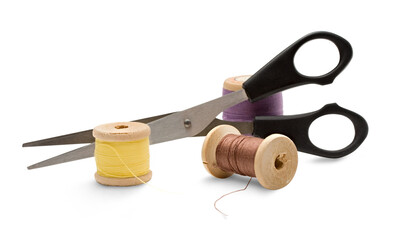 Thread bobbin and scissors on the white background