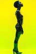 © Nejron Photo - Glossy high-fashion outfit contrasts vivid yellow backdrop.