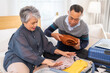 © Art_Photo - Senior couple packing suitcase for travel, asian elderly preparing for vacation, grandparents organizing luggage, retirement travel planning enjoying trip preparation packing essentials for holiday