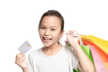 A young girl is holding a credit card and a bunch of shopping bags