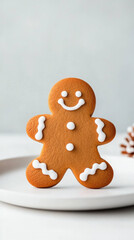 single gingerbread cookie with smiling face and decorative icing sits on white plate, evoking warm and festive atmosphere