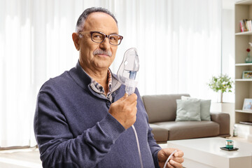 Mature man holding a nebulizer mask