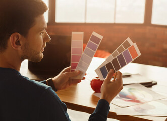 Poster - Designer's Lifestyle. Millennial Guy Working With Color Palettes And Samples Sitting At Laptop In Modern Office. Selective Focus