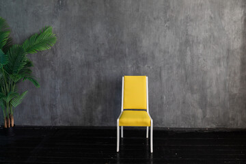 Sticker - Yellow old chair with green plant in empty room interior