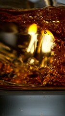 Poster - Super slow motion of pouring whiskey or rum with ice cubes in detail. Filmed on high speed cinema camera.