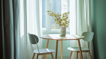 Two mint color chairs at round wooden dining table against window dressed with grey and white curtains. Scandinavian interior design of modern dining room