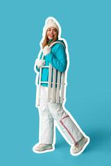 Poster - Beautiful young happy woman in warm winter clothes with sledge on blue background