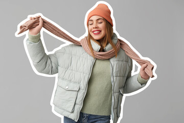 Wall Mural - Beautiful young happy woman in warm winter clothes on grey background