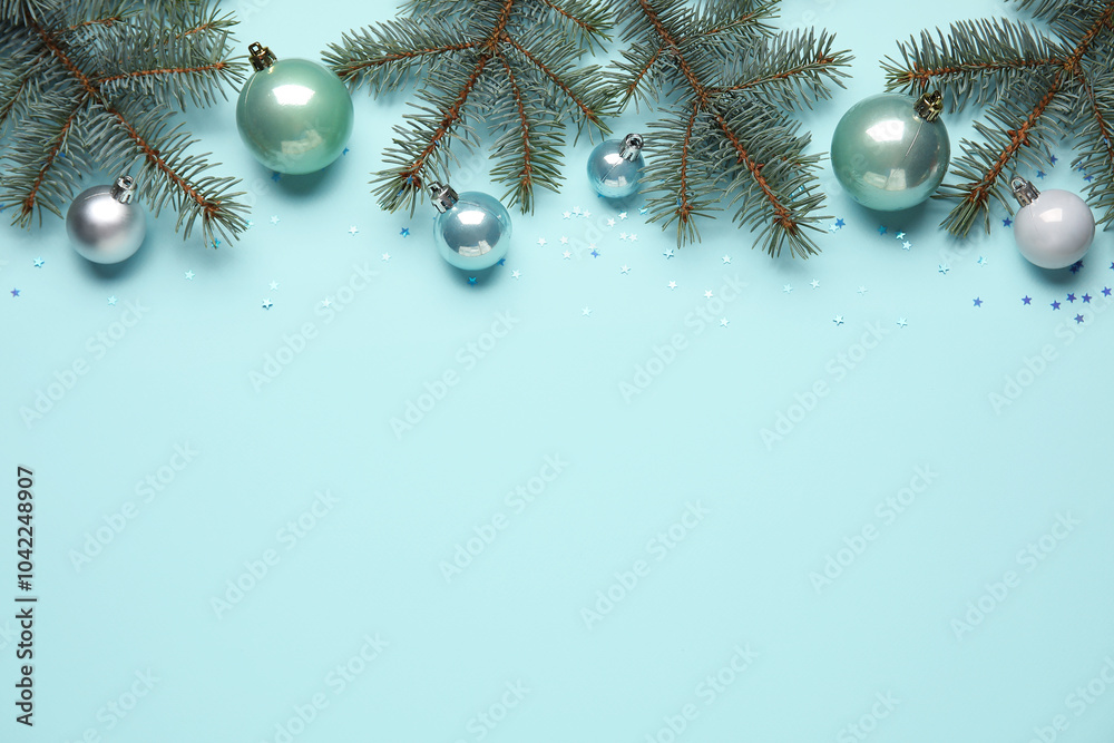 Composition with beautiful Christmas balls and fir branches on color background