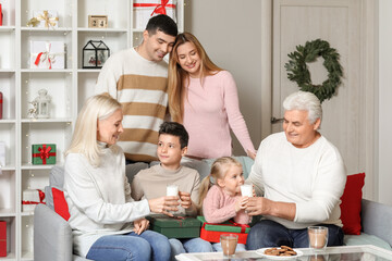 Happy family with Christmas cookies and milk at home