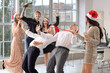 © Pixel-Shot - Young colleagues with champagne having fun at New Year party in office