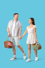 Sticker - Young couple with picnic baskets on blue background