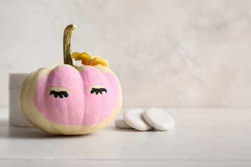 Canvas Print - Pumpkin with clay mask and spa stones on white wooden table against grunge background