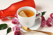 © Pixel-Shot - Cup of diet tea, measuring tape and bottle with water on light table. Weight loss concept