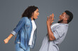 © Prostock-studio - PMS Concept. Mad african american woman yelling at her scared boyfriend, shouting with rage on light studio background, empty space
