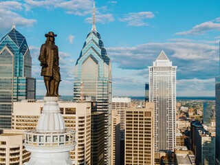 Wall Mural - Statue of William Penn on top of  Philadelphia City Hall and the downtown city skyline of Philadelphia, Pennsylvania, United States.