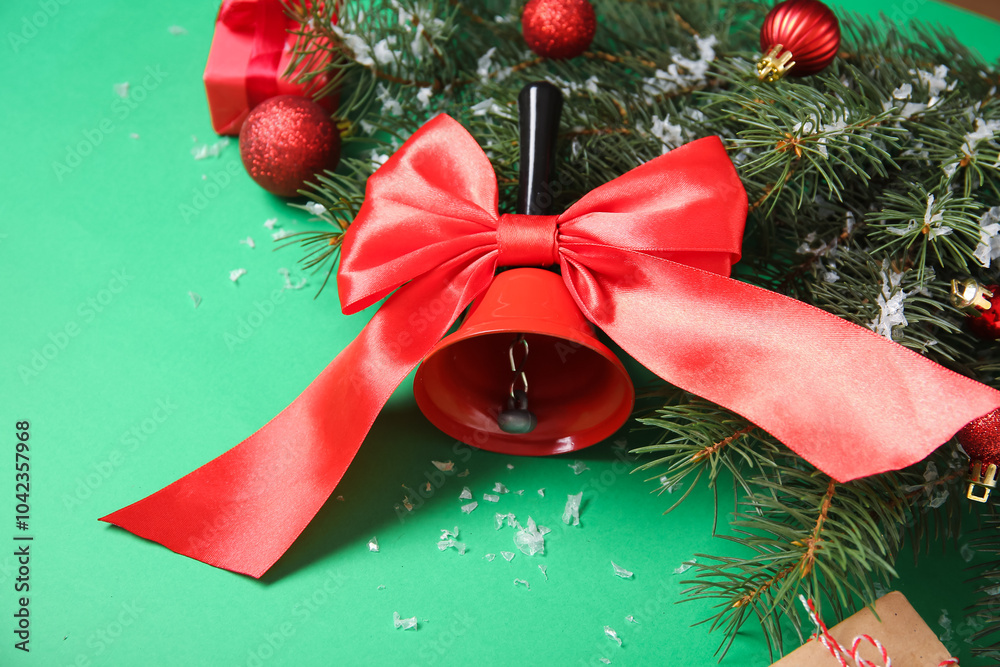 Christmas bell with fir branches and balls on green background
