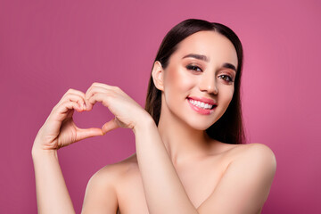 Wall Mural - Photo of joyful girl show make heart shape fingers love sign toothy smiling on pink background