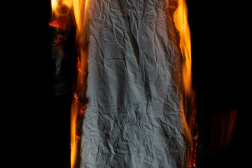 Wall Mural - burning paper, glowing edge of paper on a black background