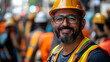 © Siasart Stock - Smiling construction worker in safety gear amidst a busy site.