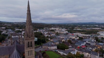 Wall Mural - Aerial view over the town of Letterkenny in Ireland in the evening - The urban landscape during sunset showcases vibrant, colorful buildings against a backdrop of a dramatic sky