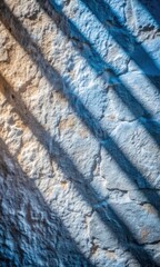 Canvas Print - Blue shadows creating patterns on a textured surface.