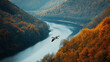© GoldPumaze - A lone wild goose flying above a river winding through autumn hills at Thanksgiving.