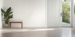 © JuanM - Bright minimalist interior with a bench and large sliding door leading to a garden area