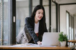 © Witoon - Freelance Asian businessman working independently using tablet computer in modern office. Accounting analysis report, real estate investment information, financial and tax concept.