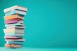 © wiraphat - Stack of Colorful Books on Simple Background