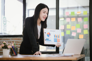 Beautiful Asian businesswoman working on laptop in office