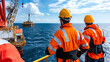 © A-TiMe  - Workers conducting crane inspections on offshore oil rig ensuring safety and efficiency in marine operations under clear skies
