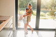 © Abrahams/peopleimages.com - Love, hug and smile with sisters in house for bonding, support and happiness together. Youth, siblings and care with children embrace in kitchen of family home for morning, connection and peace