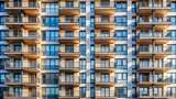 Extreme close-up of a tall building with many windows and a balcony.