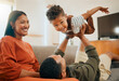 © Abrahams/peopleimages.com - Funny, airplane and energy with family on sofa for love, playful game and happiness together. Care, bonding and laughing with parents and child in living room at home for silly, comedy and support