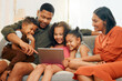 © peopleimages.com - Tablet, streaming and relax with family on sofa for love, online game and happiness together. Movie, bonding and social media with parents and children in living room at home for film, app and care