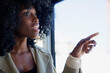 © Johnér - Curly haired woman pointing at window in cable car