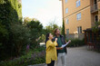 © Johnér - Male and female architects examining residential building while standing on footpath