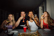 © Johnér - Friends eating pizza during party at home