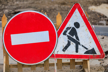 Two signs warning of ban on entry and that road repair work is underway