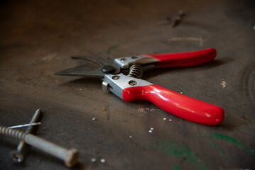 Red and metal pliers on simple background.