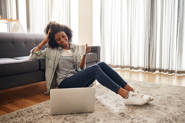 Canvas Print - Laptop, streaming and woman and coffee on floor for relax, subscription service and movie. Website, internet and home cinema with person drinking tea in living room of house for digital and film