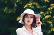 © peopleimages.com - Nature, elegant or portrait of woman with hat, trees or wellness for travel, break or fashion. Explore, trendy and female person on holiday in garden for vacation, classy style and feminine clothes