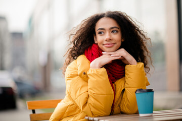 Photo of pretty lovely girl wear coat sit cafe terrace drink hot latte cold autumn day outdoors outside