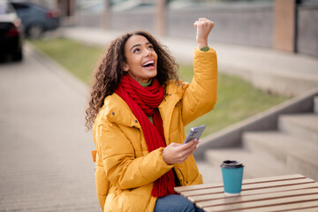 Photo of cute cheerful girl wear windbreaker cafe terrace drink hot cacao cold autumn day outdoors outside