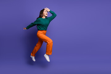 Wall Mural - Full length portrait of nice young girl jump run empty space ad isolated on violet color background