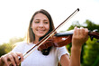 © peopleimages.com - Park, music and child with violin in morning for playing, practice and learning skills outdoors. Happy, musician and girl with musical instrument for talent show, performance and recital in nature