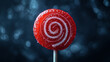© SashaMagic - Red lollipop with sugar swirl against dark background