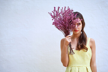 Wall Mural - Wall, bouquet and flowers with woman in portrait, surprise and present of lavender for valentines day. Hand, female person and hide with floral bunch for anniversary, scent gift plant or mockup space